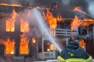 Fireman putting out house fire