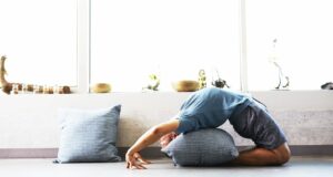 Man doing yoga at home