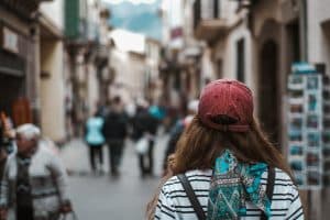 Lady In Red Cap Walking Down A Street