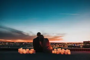 Couple Overlooking City At Night Time